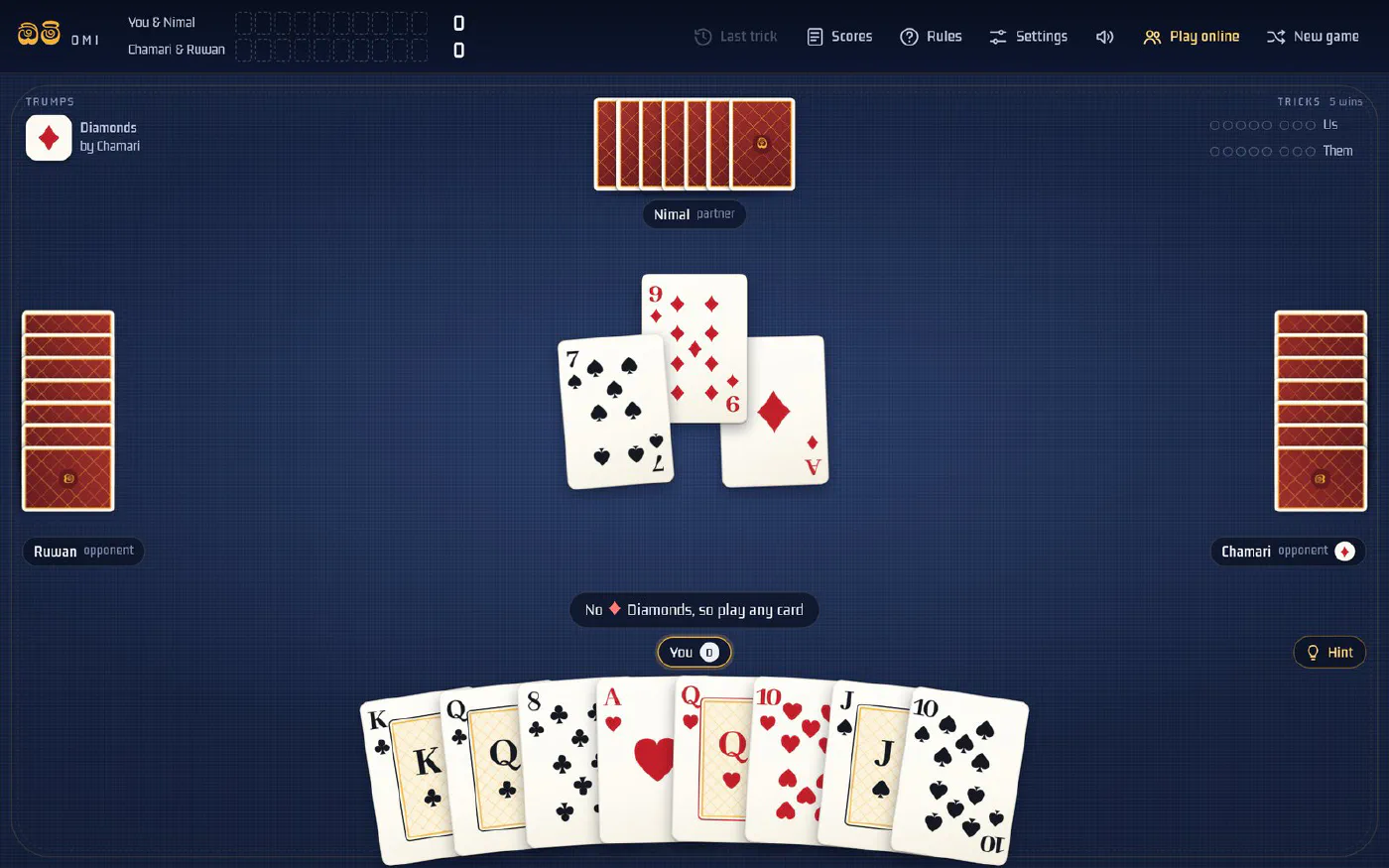 Omi mid-hand: diamonds are trumps, three cards sit on the table, and your hand is fanned along the bottom
